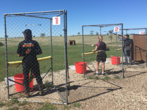 In the Cages. Student athletes take their shot in the 5-stand state tournament. Pictured are JJ Entzel, of Bismarck’s Legacy High School, Halle Dunlop of Bismarck’s Century High School and Bryce Brendel, Mandan High School. 5-Stand is one of two new additions along with sporting clays to the USA CTL shooting sports offerings this season. Simonson Photo.