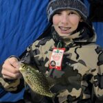 Some Things Never Change. The author’s godson, Gavin Schreurs of Russell, Minn. with a crappie from the weekend adventures. Simonson Photo.