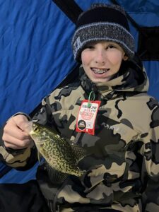 Some Things Never Change. The author’s godson, Gavin Schreurs of Russell, Minn. with a crappie from the weekend adventures. Simonson Photo.