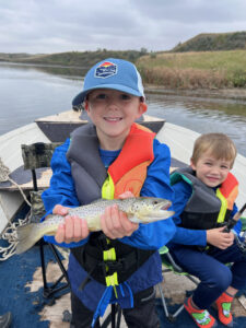 Fast Fishing. Cannon Schmitt of Bismarck, N.D., holds up his first brown trout while the author’s son, Jackson, looks on during a short fishing trip. Simonson Photo.