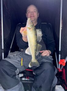 On Screen, IRL. The author’s friend, Josh Holm of Valley City, ND, with a walleye pulled up from under the ice and observed by the author on high-end sonar the whole time. Simonson Photo.