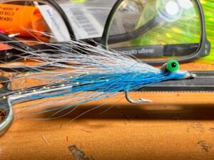 On Point. Even fresh hooks out of a pack, like this one used to make a Clouser Minnow for next spring’s crappie fishing, can use a little sharpening. Having a hook honing tool like the one holding the fly can help sharpen things up ahead of the season, or just before a cast. Simonson Photo.