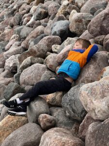 The author’s son Jackson finds a space to relax amidst the rocks along the shores of the Sheyenne River near the Baldhill Dam north of Valley City. Simonson Photo.