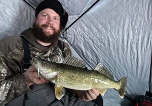 The author’s brother, Ben Simonson, of Valley City with a midwinter walleye. By adjusting the presentation with a favorite spoon to a more subtle action, he was able to connect with the fish. Simonson Photo.
